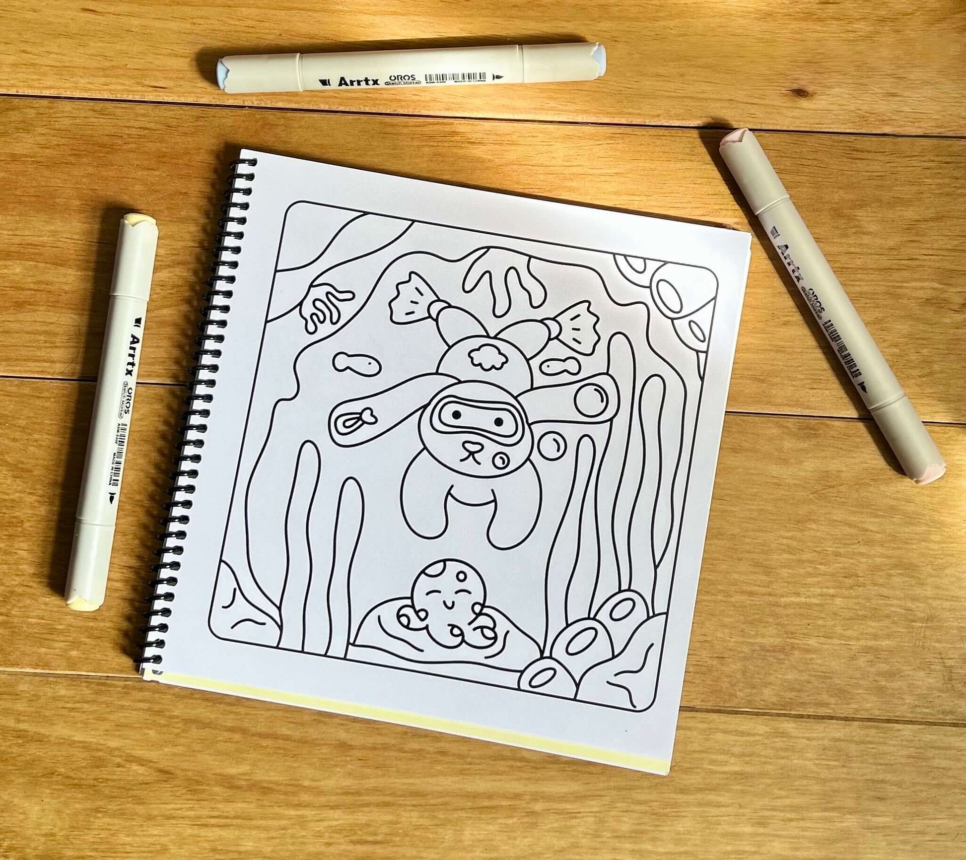 Uncoloured cute fish design inside the Bubbly Underworld Friends book with colouring pens.