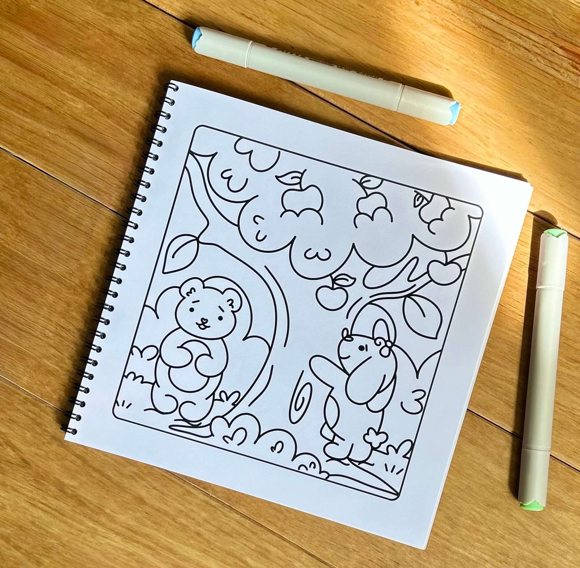 Close-up of an intricate, uncoloured woodland animal pattern page ready for colouring.